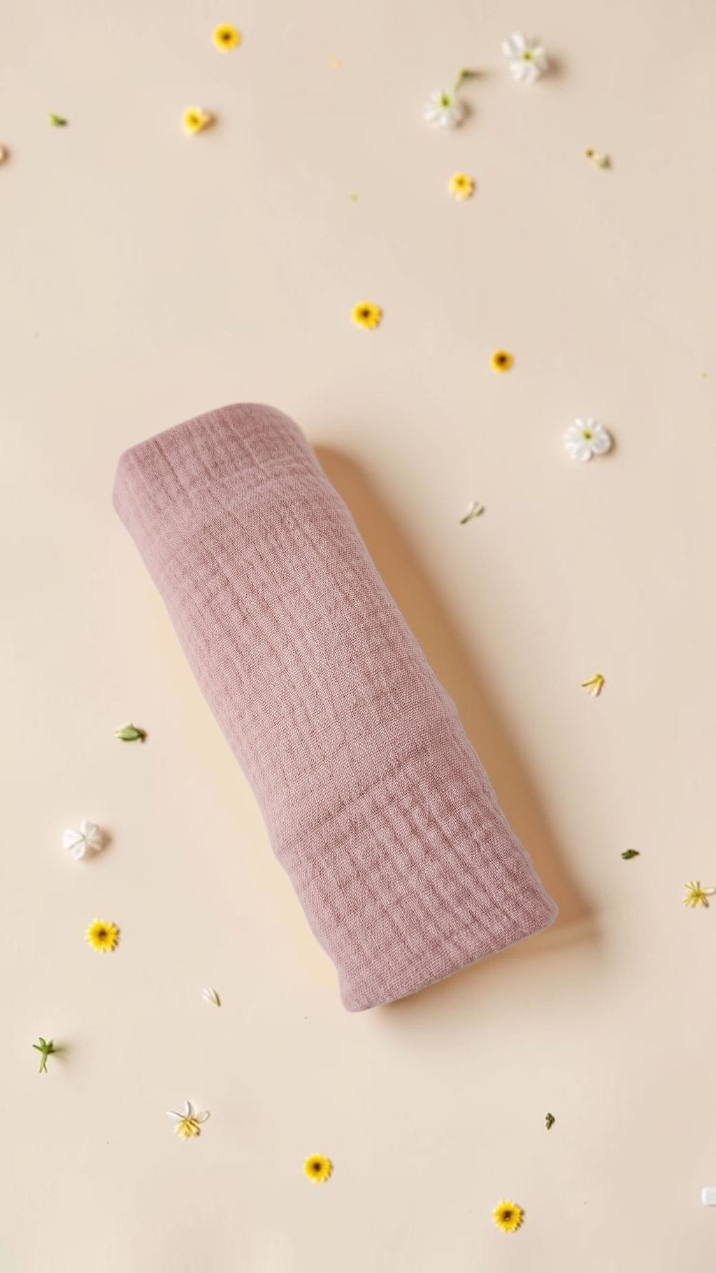 Cloudy Cotton dusty rose organic muslin baby swaddle wrap with soft breathable texture on a floral background